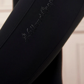 Black riding leggings with decorative Holland Cooper wording on a neutral background